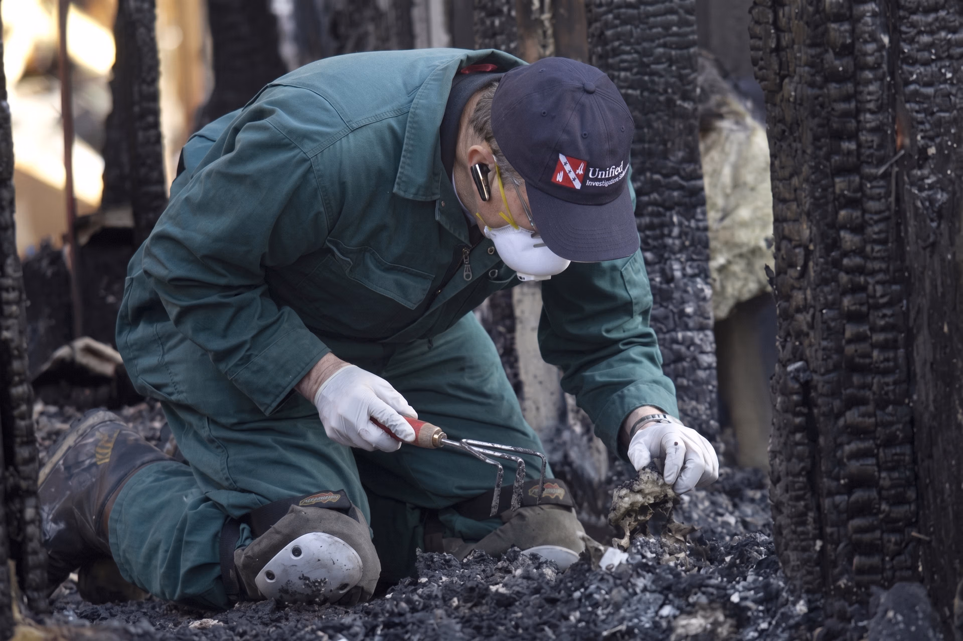 A forensic investigator looking at fire debris