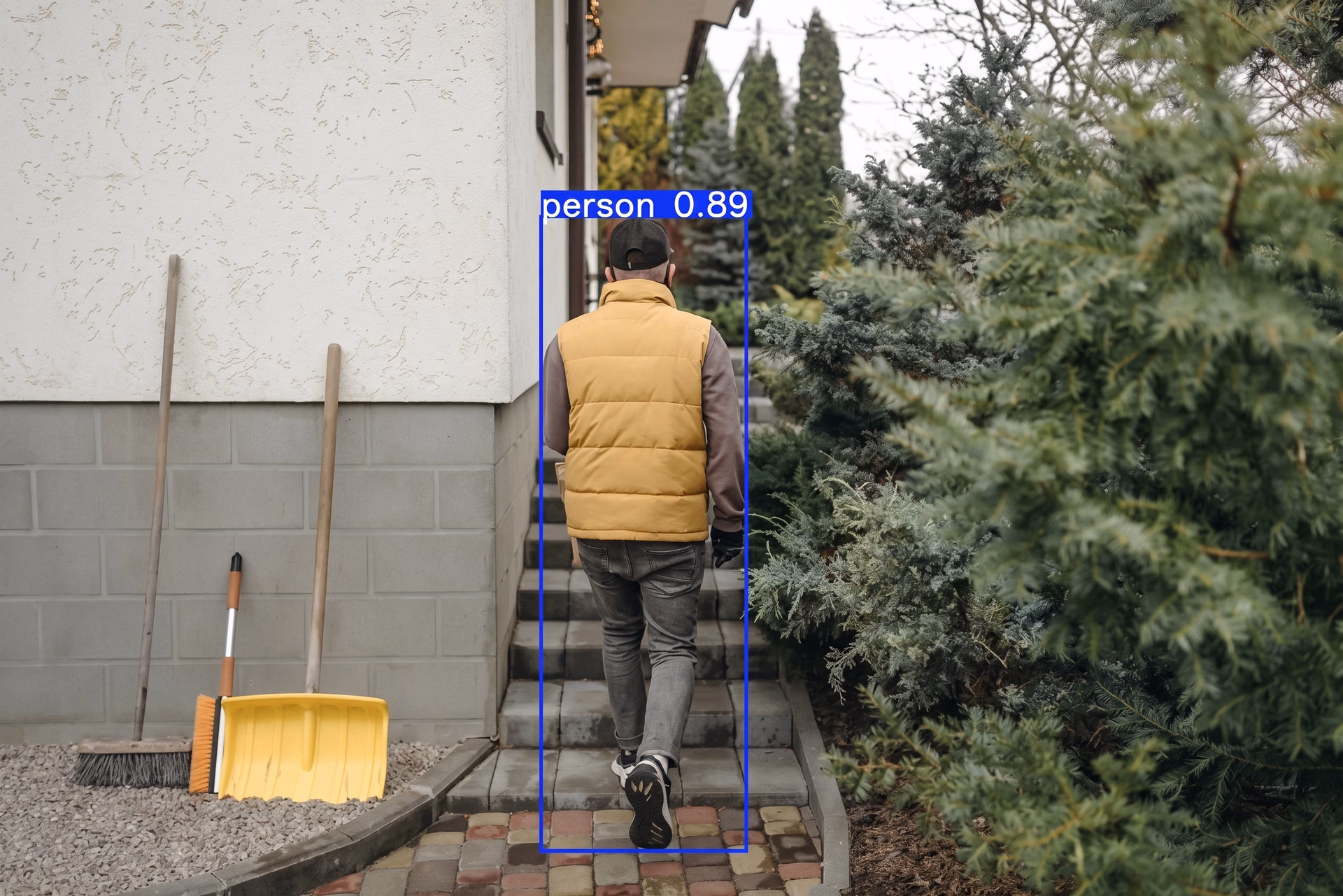 Detecting someone in a backyard using an Ultralytics YOLO model