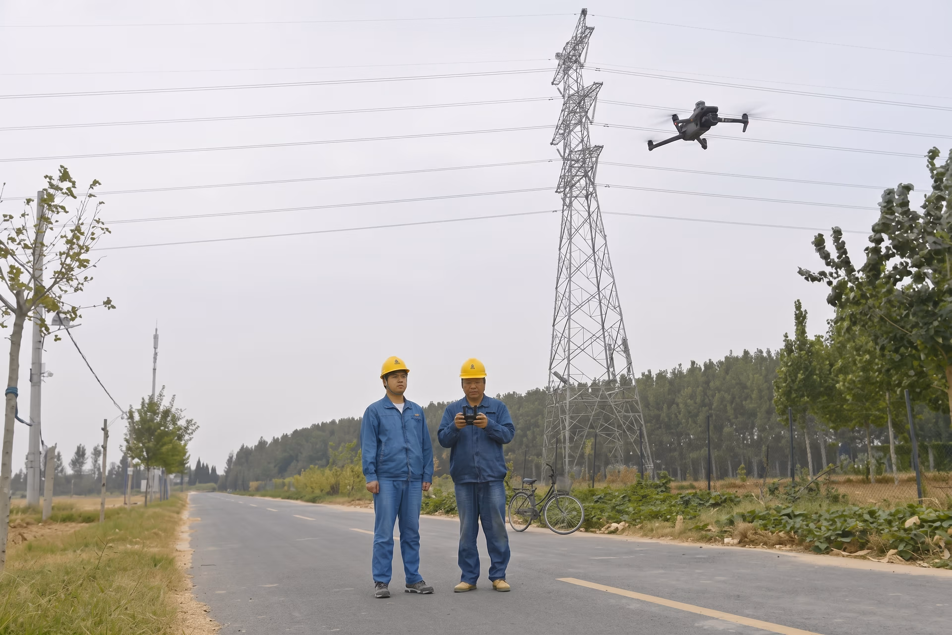 Workers inspecting an electrical line using drones