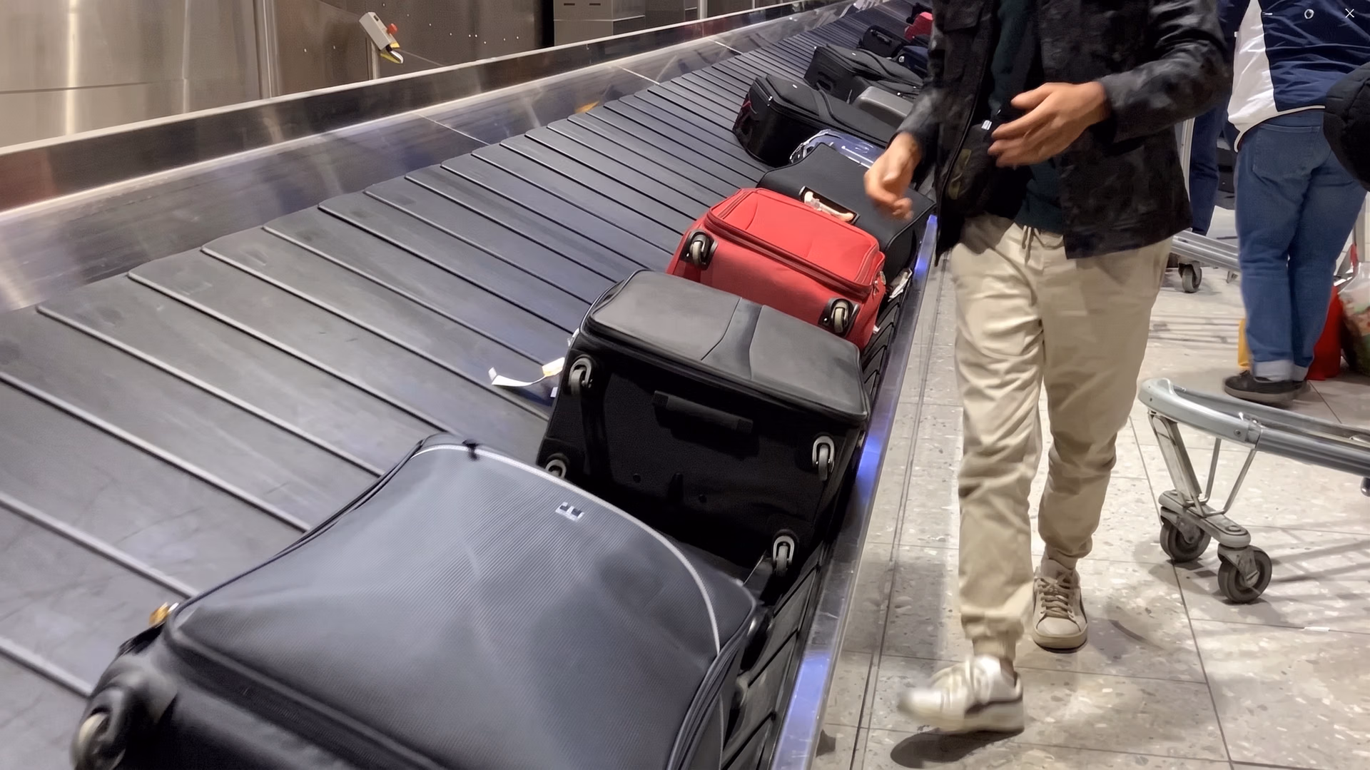 A frame from the input video showing baggage handling in an airport terminal