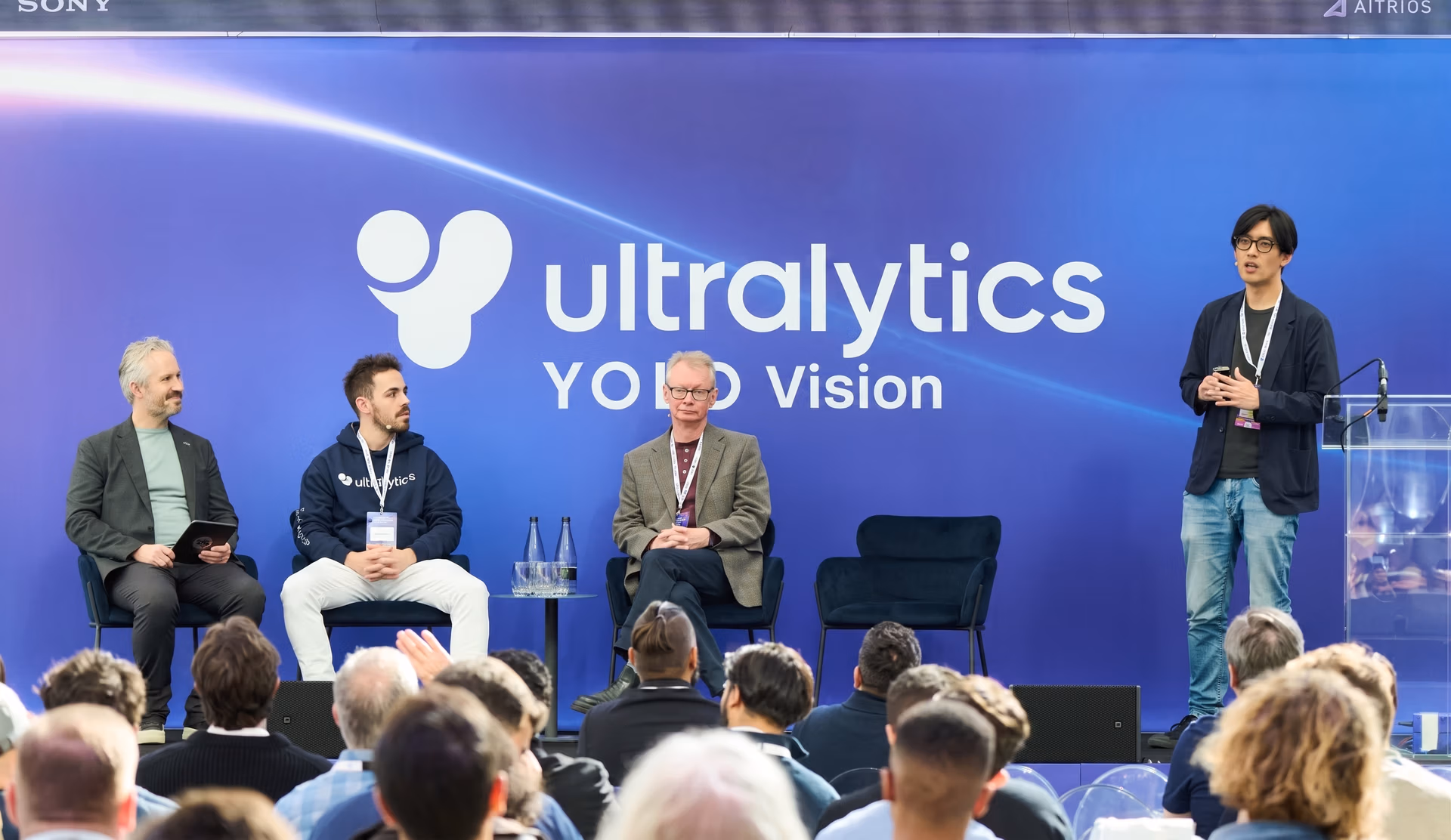 A panel on edge deployment featuring Oisin Lunny, Yuki Tsuji, David Plowman, and Glenn Jocher