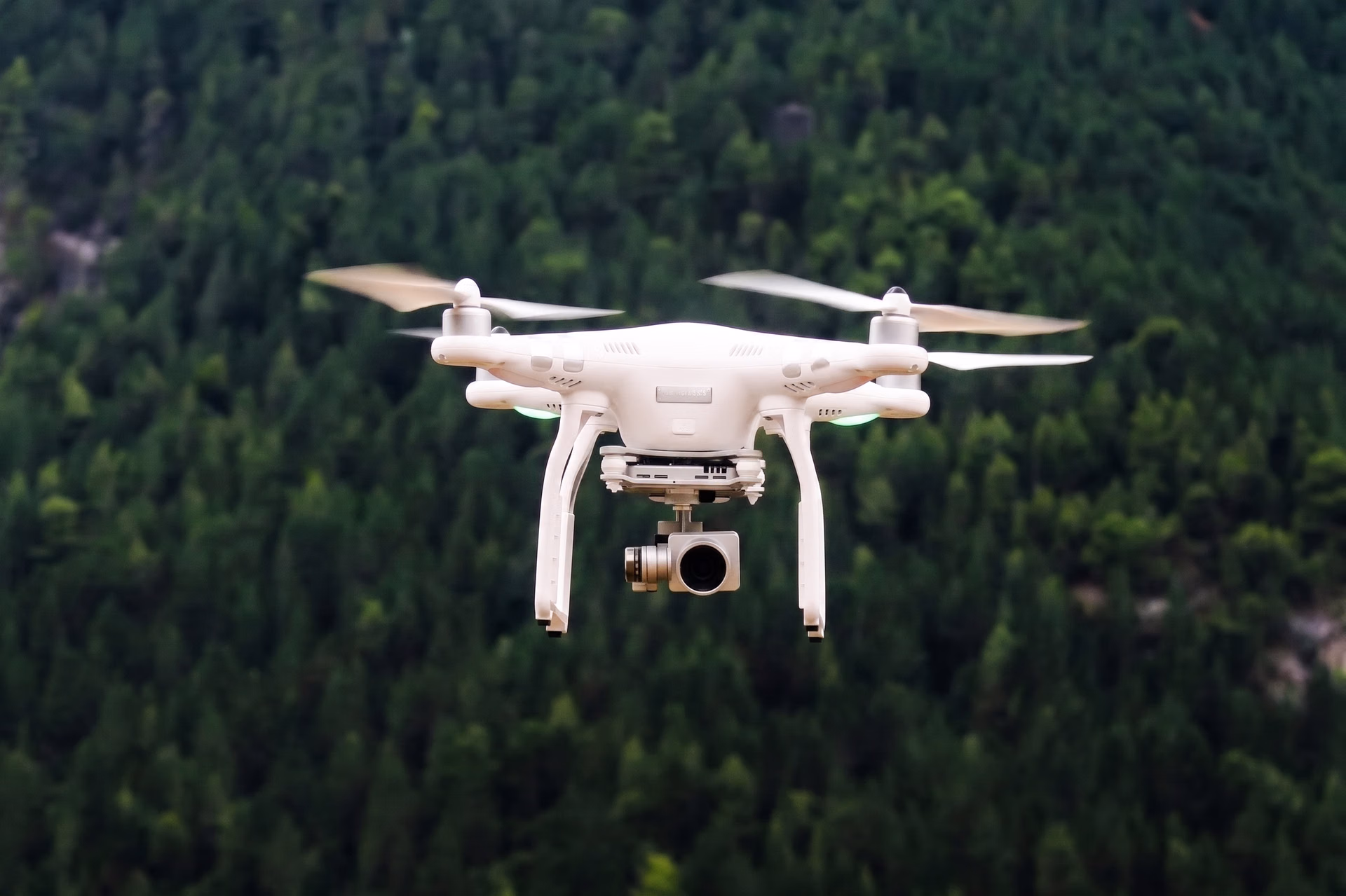 A drone hovering over a forest