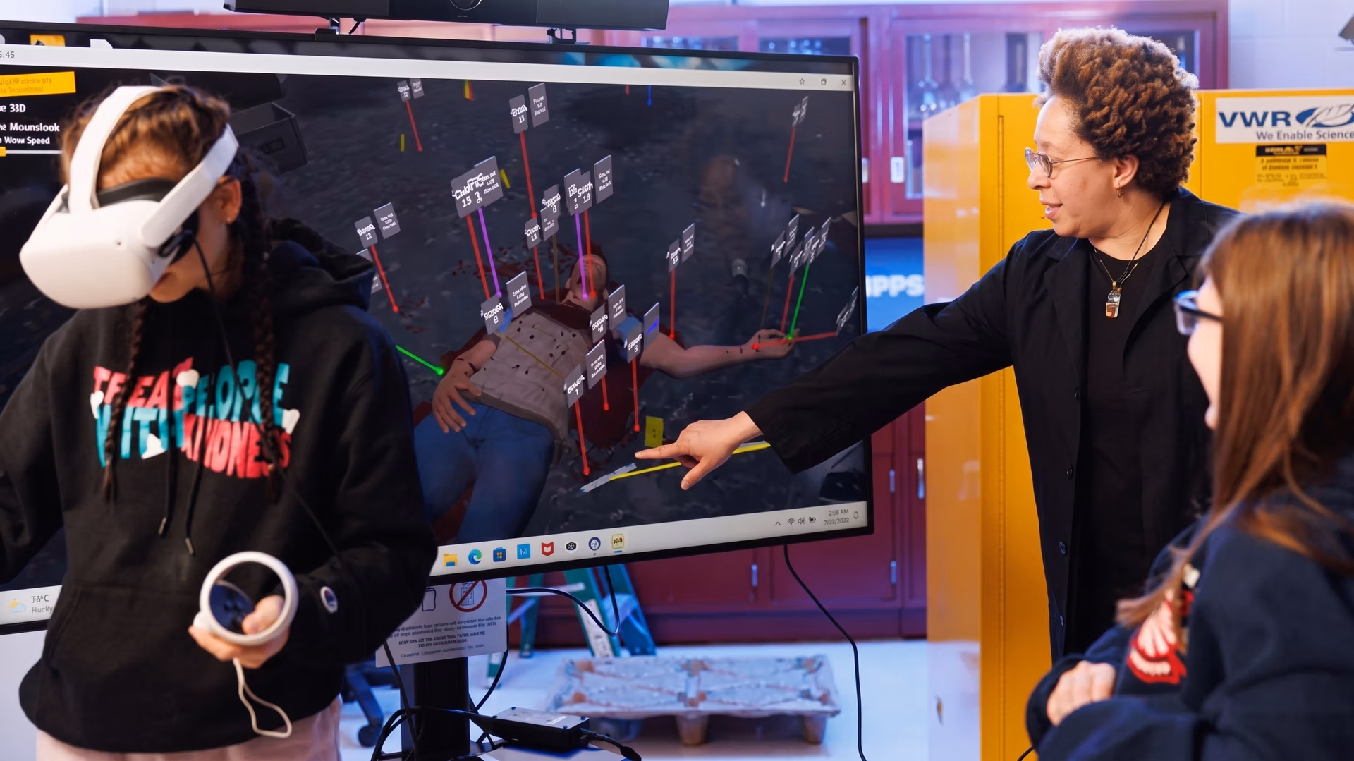 A student looking at a crime scene using a VR headset